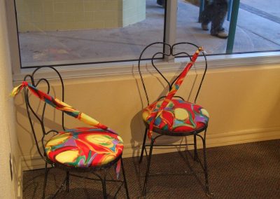 picture of two chairs with mendoza's painting on the seats