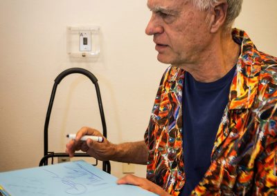 george mendoza signing a copy of his book