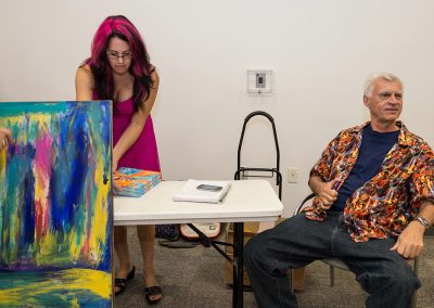 mendoza sitting down at his book signing