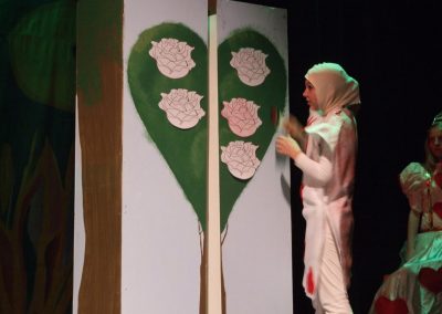 child dressed as a playing card in alice in wonderland