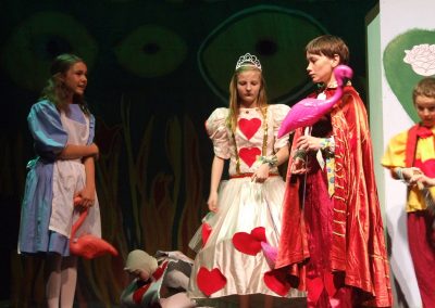 alice and the queen of hearts playing croquet