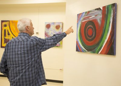 mendoza pointing at his painting