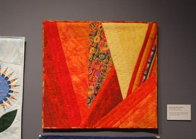 photo of mendoza's quilting work with red and yellow shapes