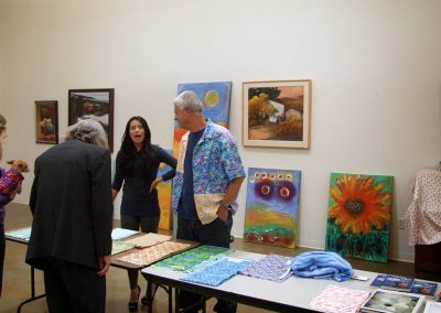 mendoza stood in front of artworks with others