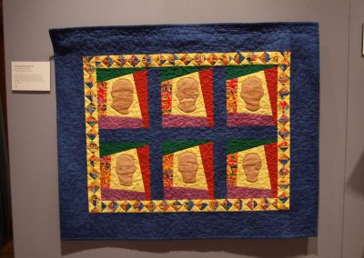 photo of mendoza's quilting work with six heads