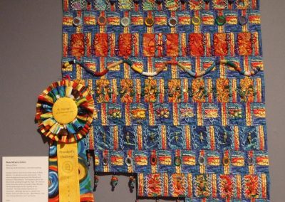 photo of mendoza's quilting work of a multicolored landscape