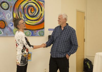 mendoza shaking hands with a woman