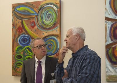 mendoza talking with a man at the gallery