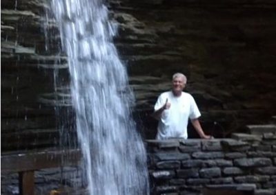 mendoza posing next to a waterfall