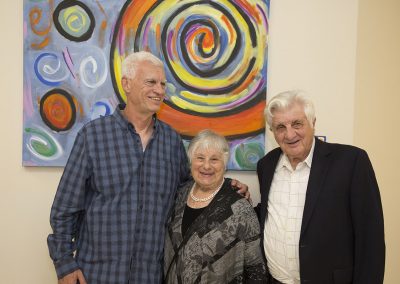 mendoza posed with a woman and a man in front of his painting