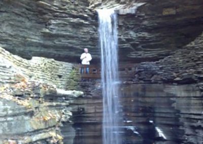 mendoza standing next to a waterfall