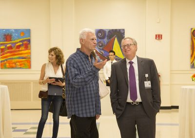 mendoza talking with a man at the gallery