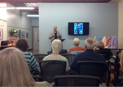 mendoza stood in front of a group of people expressively explaining his process