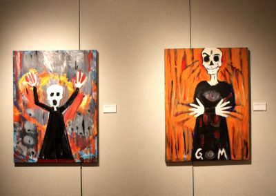 photo of mendoza's artworks in a gallery of two figures